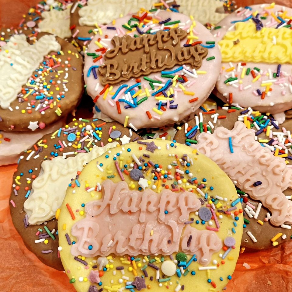 Happy Birthday dog cookies decorated with sprinkles