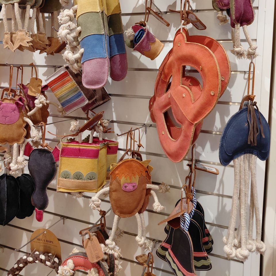 Close-up of felt and leather dog toys shaped like a cactus, a pretzel and birds